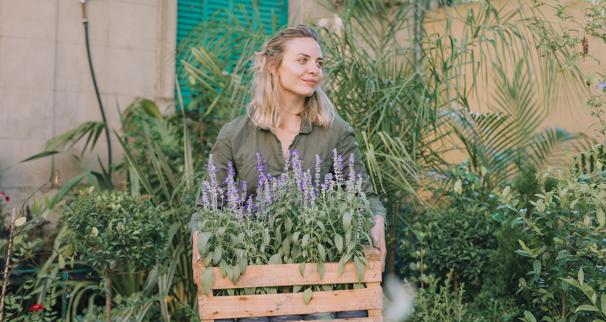portrait-female-gardener-holding-wooden-crate-lavender-flowers