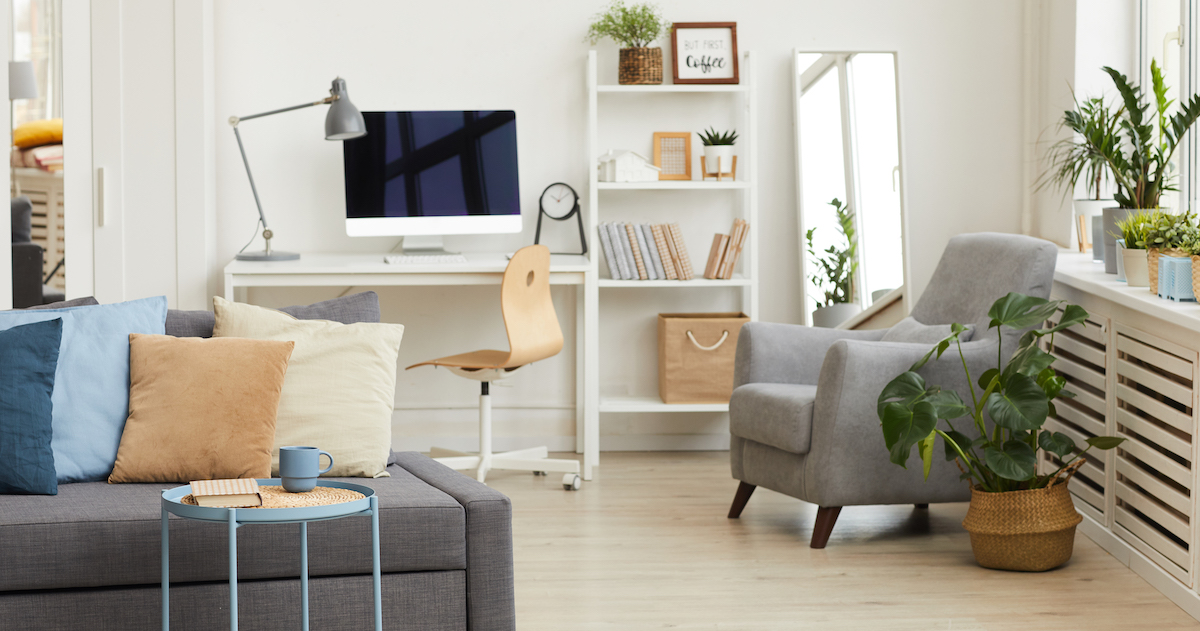 cozy-apartment-interior-grey-white-colors-focus-modern-sofa-with-decor-elements