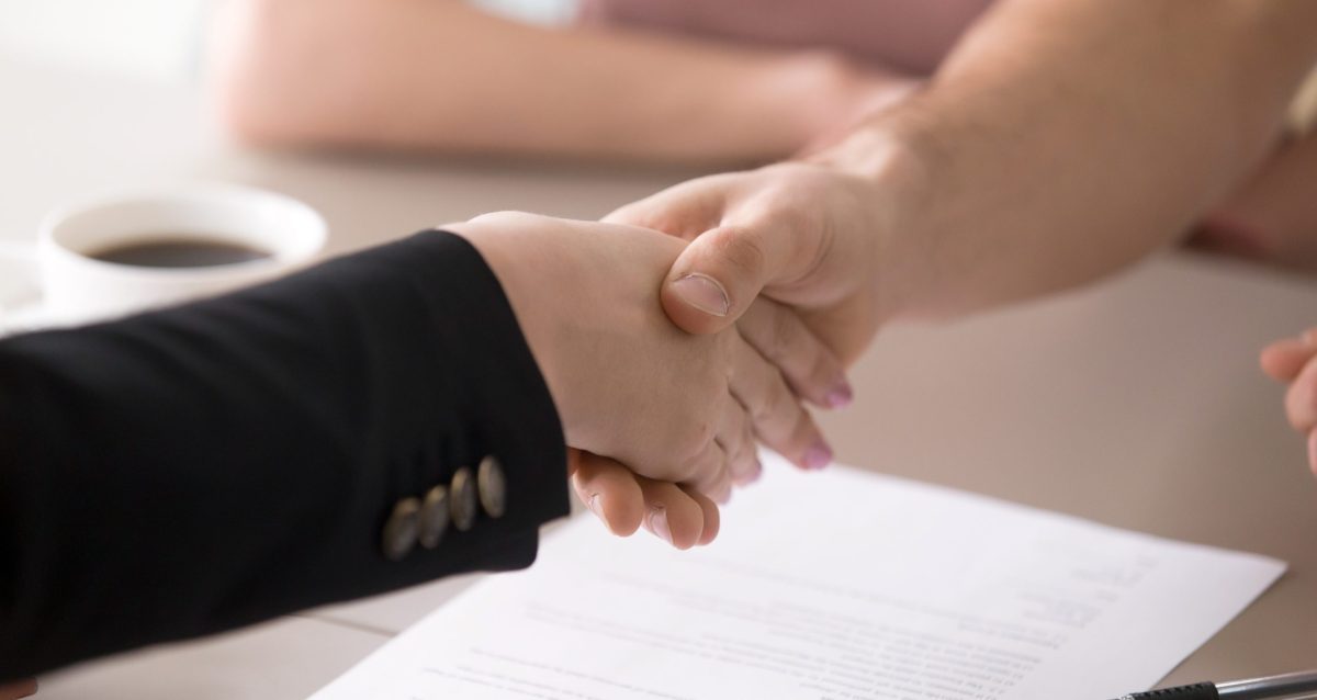 man-woman-handshaking-after-signing-documents-successful-deal-closeup-1-scaled-e1637666629445
