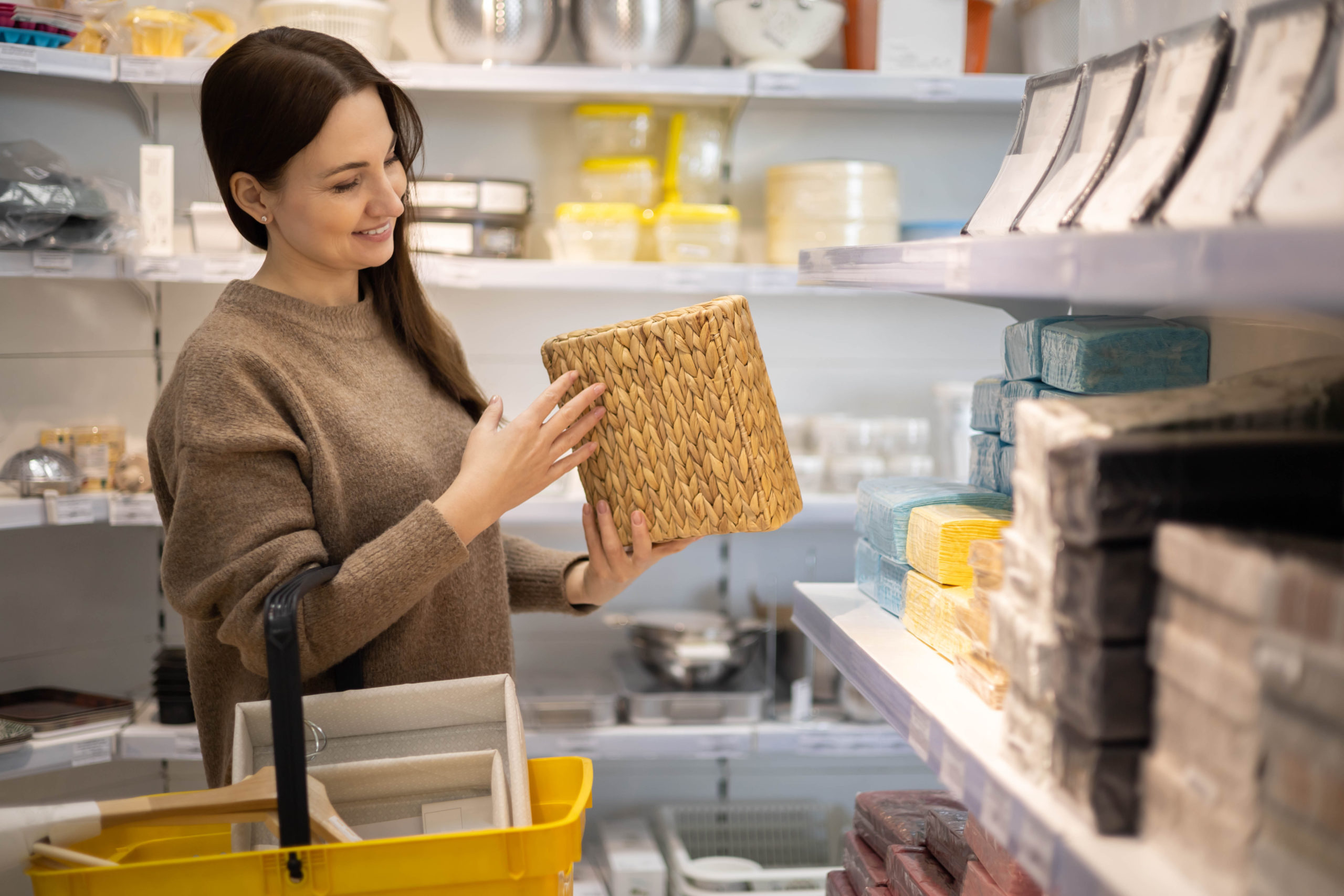 smiling-female-housewife-choosing-straw-basket-container-interior-decor-space-organizing-scaled