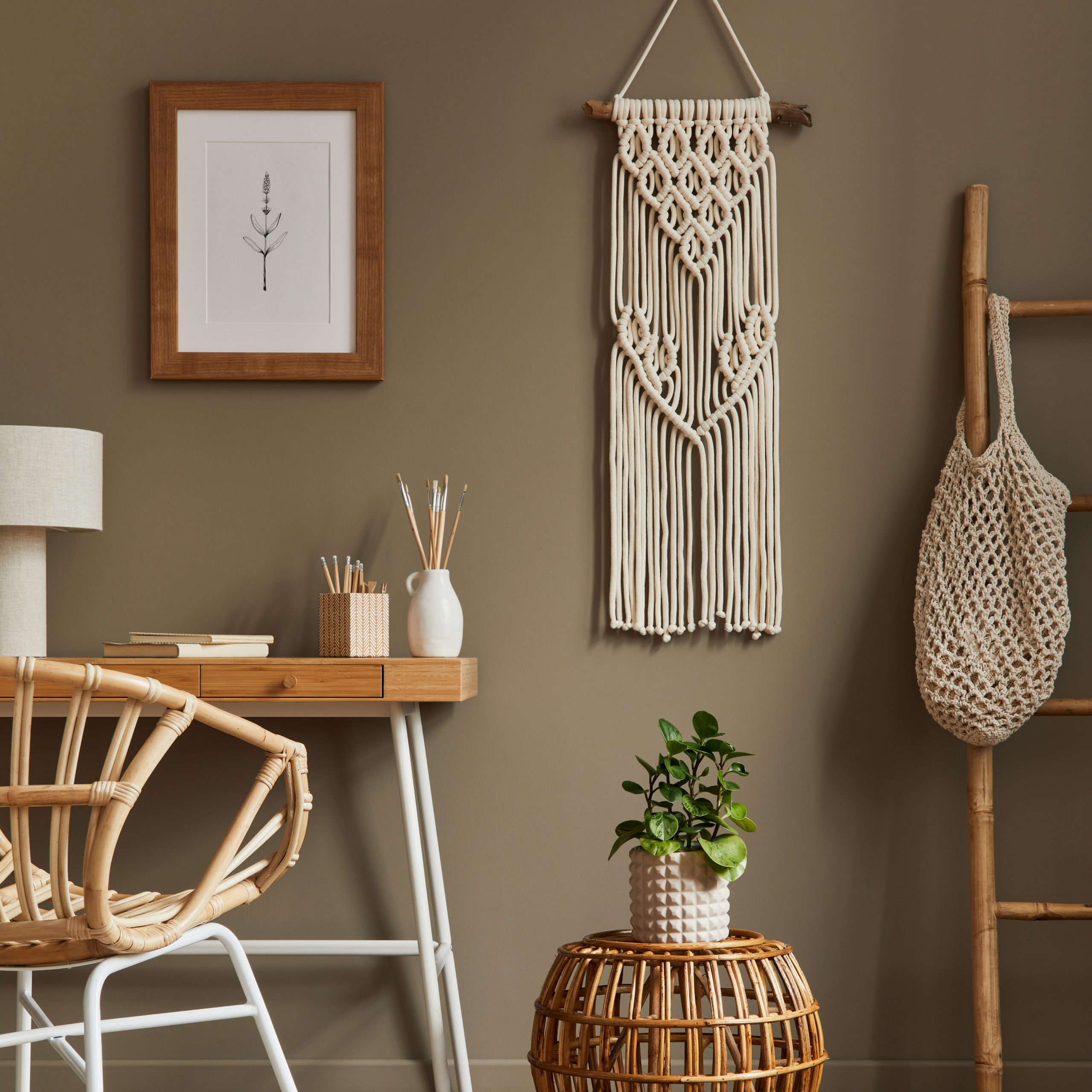 stylish-bohemian-interior-home-office-space-with-wooden-desk-rattan-armchair-brown-mock-up-poster-frame-macrame-office-supplies-lamp-decoration-elegant-personal-accessories-home-decor-scaled